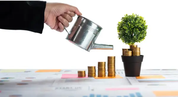 Main qui arrose une plante faite de pièces d'or, symbolisant la croissance d'un nouveau source de revenu.